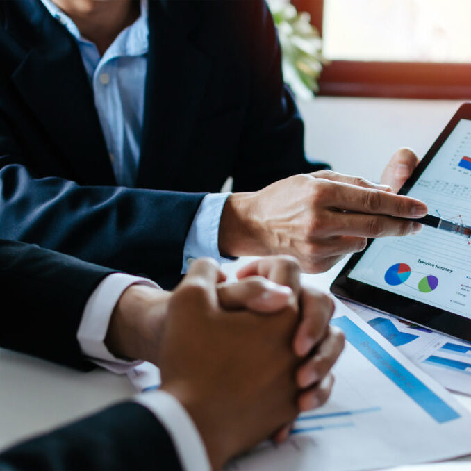 partner-business-man-investor-team-brainstorming-planning-about-financial-statistics-chart-information partner business man investor team brainstorming and planning about financial statistics chart information in mobile tablet together in meeting room at office, finance, investment and digital concept